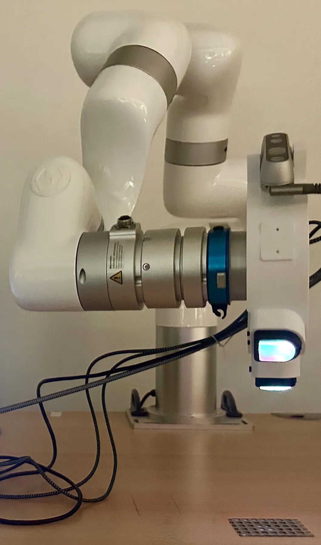 Collection setup: robot arm with a rotating adapter holding three DIGIT tactile sensors above an industrial material sample.